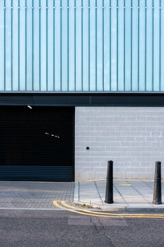 Modern warehouse with a sleek metal facade, combining industrial simplicity with contemporary urban form.