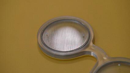 Handheld Bagolini glasses or filter, medical tool to use during optometrist eye exam. Vision test...