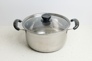 Stainless steel stewpot on white background