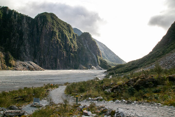 Glacial valley at Franz Josef Glacier Walk with rocky terrain and mountains on background West Coast, New Zealand