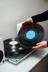 Obraz premium Vintage vinyl record from rock collection with Hi-Fi sound in musician hands. Music lover holds retro vinyl record in hands.