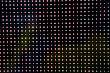 Led light grid with red and green dots creating abstract digital pattern.