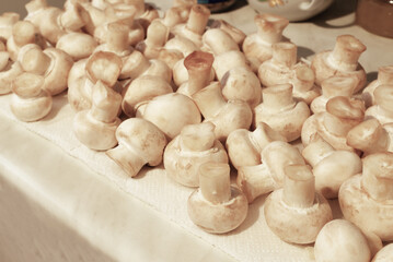 Cooking with white champignons in the kitchen.