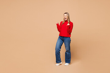 Full body side view young woman she wear red casual clothes doing winner gesture celebrate...