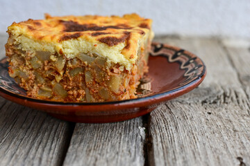  Potato and minced meat  Casserole  with   parmesan cheese and garlic on wooden rustic bakcground.  Bulgarian moussaka