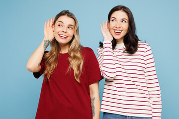 Young fun couple two friends women wear red casual clothes together try to hear you overhear...