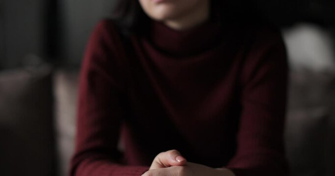 Young woman suffering from depression. Woman hands, fidget and pray, signaling mental battle. Emotional relationship and marriage crisis.