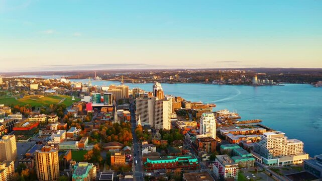Sunrise aerial drone shot over Halifax downtown, Nova Scotia, Canada.
High view of the golden landscape and sea at down as the sun is rising in the early morning.