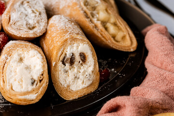 sweet rolls, pancakes with cottage cheese, raisins, apples, powdered sugar and dried cranberries, pancakes with sour cream, flatlay, beautiful light composition with dessert, roses, carnation flowers