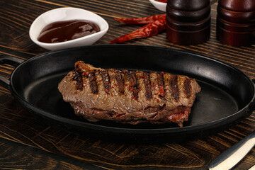 Grilled beef striploin steak with sauce