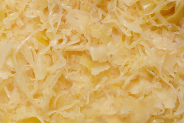 A close-up shot of sliced sauerkraut, showcasing its texture and light color
