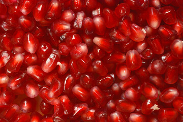 A close-up shot of pomegranate arils, showcasing their vibrant red color and juicy texture