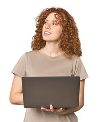 Young Caucasian redhead happy with laptop