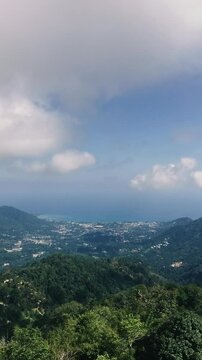 Timelapse view of the mountains of a tropical island and the ocean