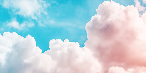Fototapeta premium Fluffy white clouds floating across a blue sky, creating a serene and peaceful atmosphere. The softness and vastness of the sky evoke a sense of calm and openness.