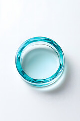 Clear blue cosmetic gel serum oil drop isolated on white background. Hyaluronic acid skincare product top view
