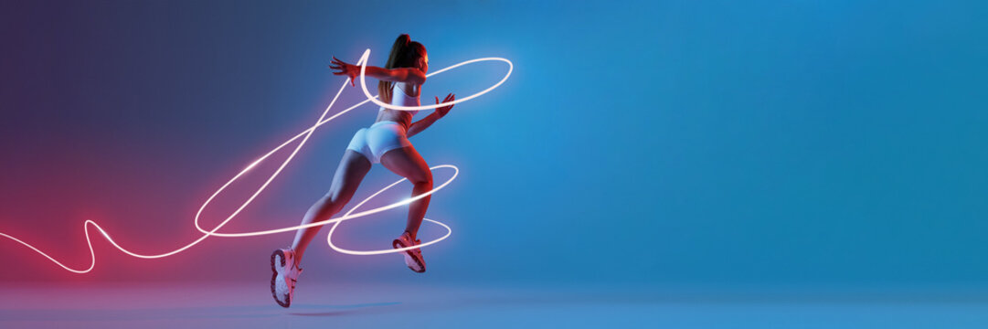 Female sprinter in athletic outfit running forward, energetic neon light trails swirling around against gradient blue-red background. Concept of sport, competition, tournament, game. Banner