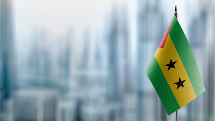 Small flags of the Sao Tome and Principe on an abstract blurry background