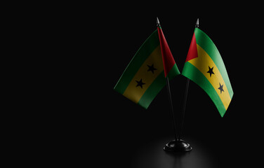 Small national flags of the Sao Tome and Principe on a black background