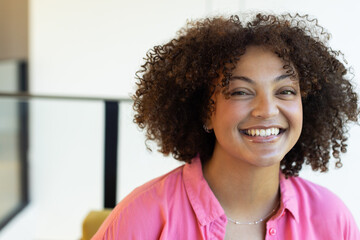 Smiling woman in pink shirt, promoting body positivity and confidence, at home, at home