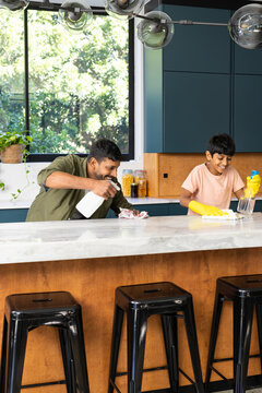 Cleaning kitchen counter, indian father and son bonding while doing household chores