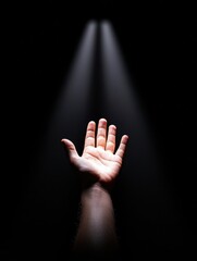 A hand reaching out, symbolizing hope and connection in a moment of solitude and introspection.