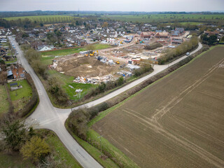Drone view of a large housing development site being constructed at the edge of the established...