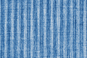 Ridge macro texture of velour corduroy blue cloth. Large ribbed, coarse weaving velveteen, striped upholstery texture fabric background, furniture textile material, design, decor