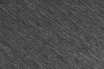 Closeup, macro of black fabric texture background. Satin diagonal weaving cloth structure, canvas. Textile for decor, upholstery, garment. Wallpaper, backdrop.