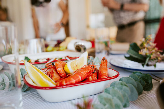 Modern Australian Christmas dinner with prawns and lemon slices