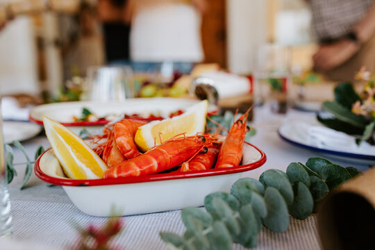 Modern Australian Christmas dinner with prawns and lemon slices
