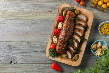Pork tenderloin, served with mushrooms and peppers.
