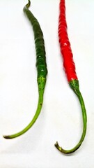 Red and green hot chili peppers on white background