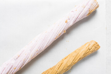 Overhead view of Nigerian Balewa candy, top view of hausa alewa candy on a white background, pulled hard sugar candy on a white countertop