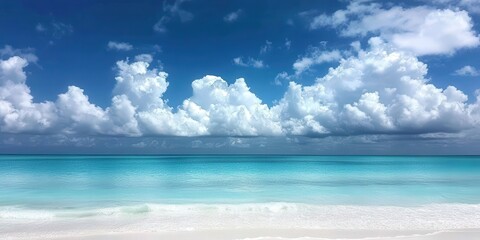 Obraz premium Sun-kissed white sand meets crystal-clear turquoise waters under a radiant azure sky; gentle, frothy waves kiss the shore, capturing serenity and vibrant hues in this idyllic beach scene