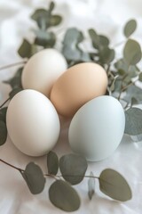 Decorated with flowers and colored eggs, a glazed kulich Easter cake rests on a white textured background. Wishing you Happy Easter holidays