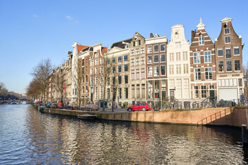 Keizersgracht in Amsterdam: Historic Canal Houses Under a Bright Blue Sky