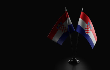 Small national flags of the Croatia on a black background