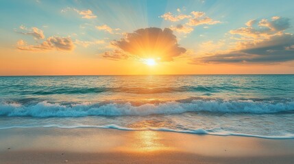 Obraz premium The sunrise at the beach paints the sky in vivid colors, with a deep blue backdrop and sunbeams