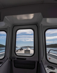 Boat is on the water with a view of the sky and the water