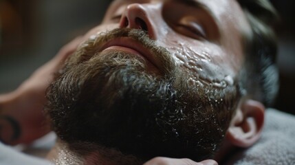 Naklejka premium A man enjoys a soothing grooming session as a barber applies a rich beard oil to enhance his facial hair while clients chat quietly in the background.
