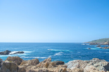 Vibrant ocean view with rocky shoreline and clear sky., Big Sur Coastline, California, USA