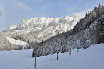 Winter panorama mountain landscape after sunrise and fresh snow fall, seen during a ski tour in the popular Kaiserau, Admont, Styria, Austria	