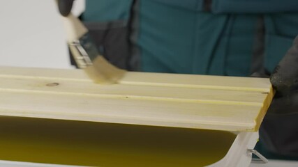 A tutorial shows treating wood with a yellow liquid, ensuring even coverage. Creative