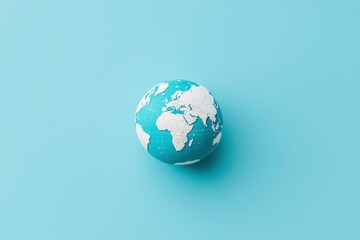 Fototapeta premium Globe on pastel blue background. Illustrates global concepts. Potential for educations