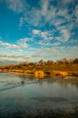 Beautiful nature on the lake ,sunrise from the hills, landscape photoshoot of beautiful red and orange sunrise , sky and clouds , reflections on water . Breathtaking sunrise , place of silence 