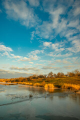 Fototapeta premium Beautiful nature on the lake ,sunrise from the hills, landscape photoshoot of beautiful red and orange sunrise , sky and clouds , reflections on water . Breathtaking sunrise , place of silence 