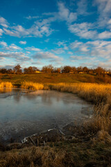 Beautiful nature on the lake ,sunrise from the hills, landscape photoshoot of beautiful red and orange sunrise , sky and clouds , reflections on water . Breathtaking sunrise , place of silence 