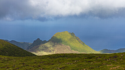 Dark clouds over volcanic cone, Isle of Flores, Azores