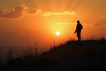 Fototapeta premium A lone soldier stands on a hill, the sun rises. The battlefield is silent, the war is finally over